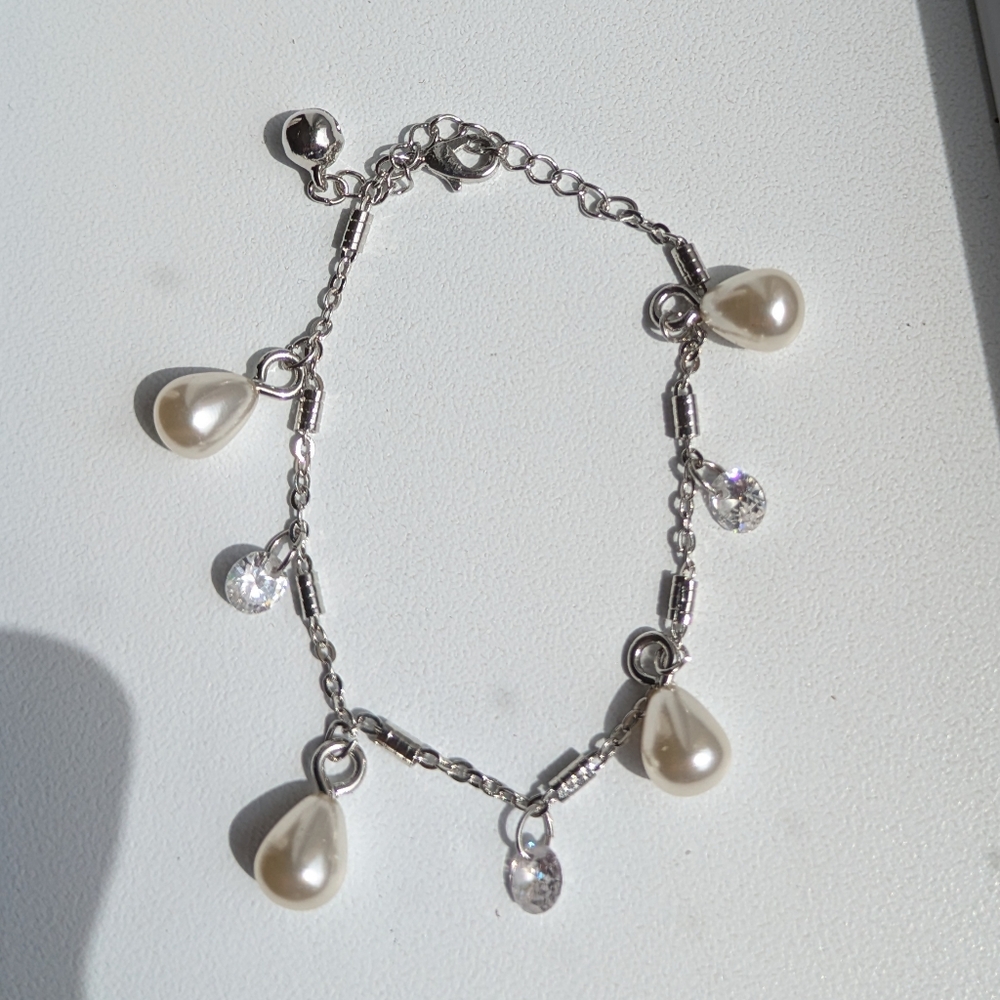 Elegant Diamond and Pearl Charm Bracelet